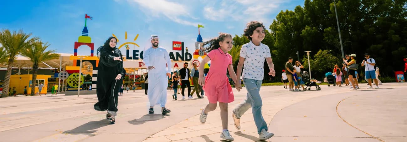 A family at the colourful entrance to LEGOLAND Dubai